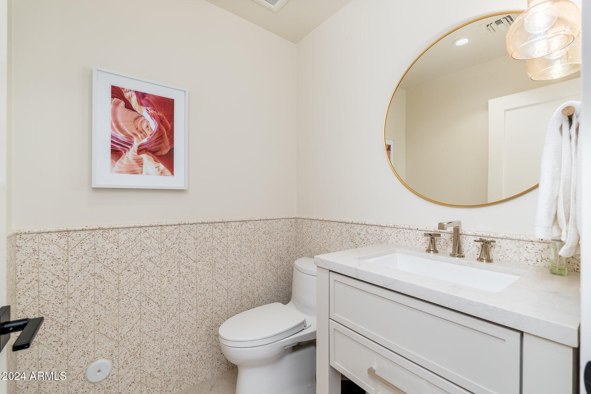 6025 East Charter Oak Road Scottsdale, AZ 85254 - Photo 45 of 115 a bathroom with a sink mirror and toilet