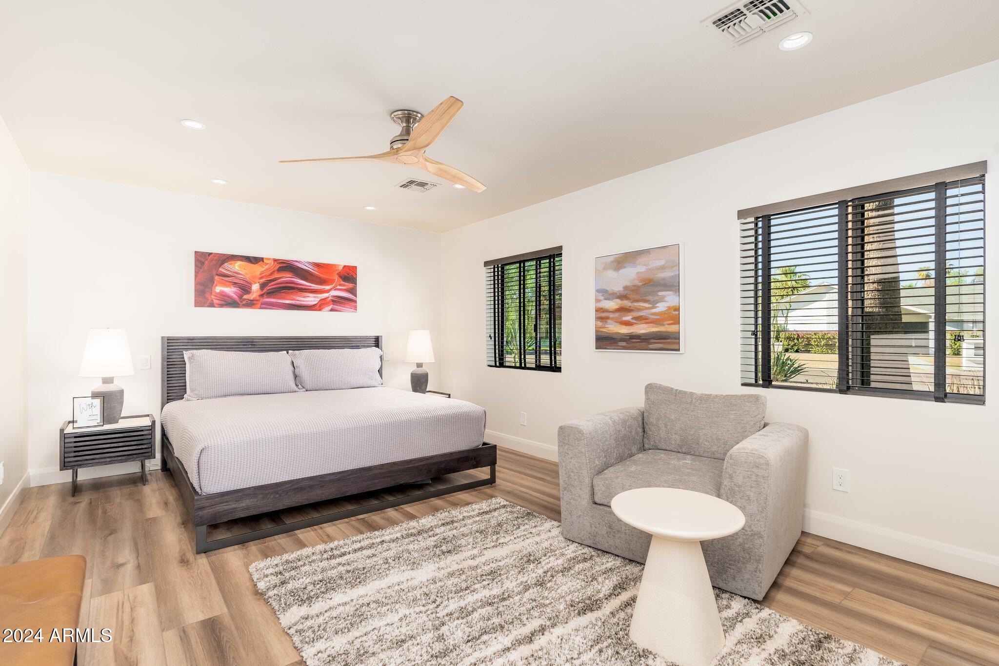 6025 East Charter Oak Road Scottsdale, AZ 85254 - Photo 48 of 115 a spacious bedroom with a bed and a couch