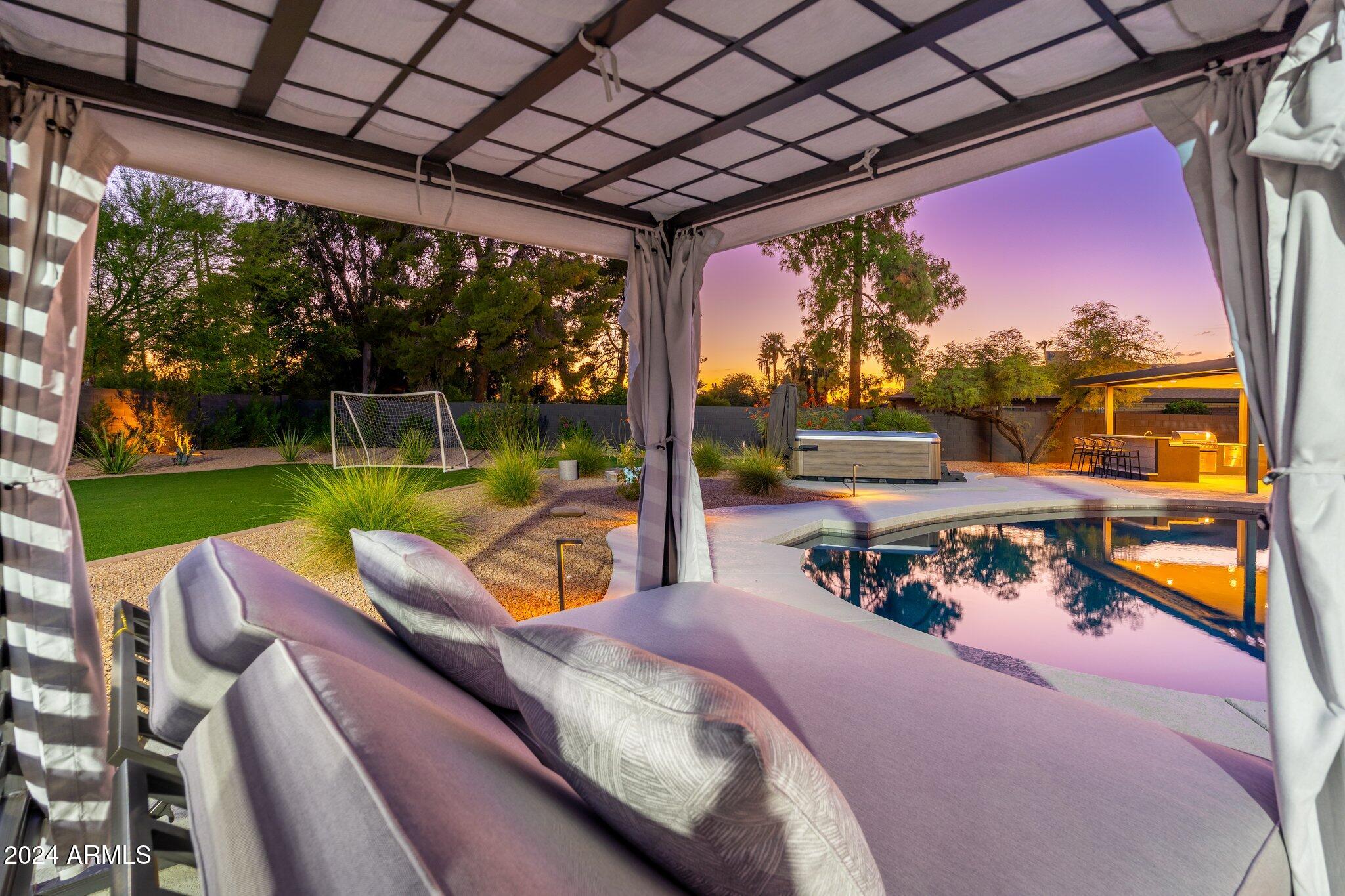 6025 East Charter Oak Road Scottsdale, AZ 85254 - Photo 63 of 115 a view of a patio with a table chairs and a backyard