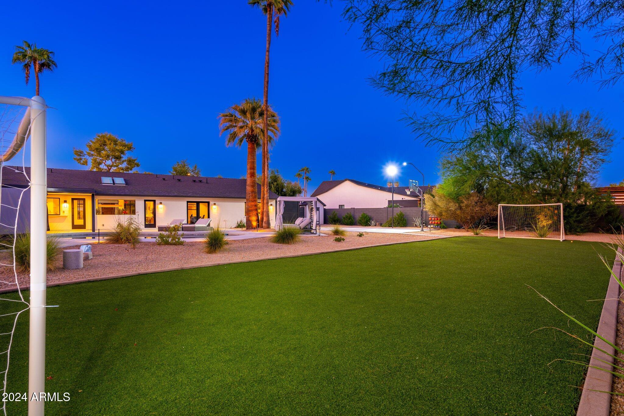 6025 East Charter Oak Road Scottsdale, AZ 85254 - Photo 66 of 115 a view of a house with a backyard porch and sitting area