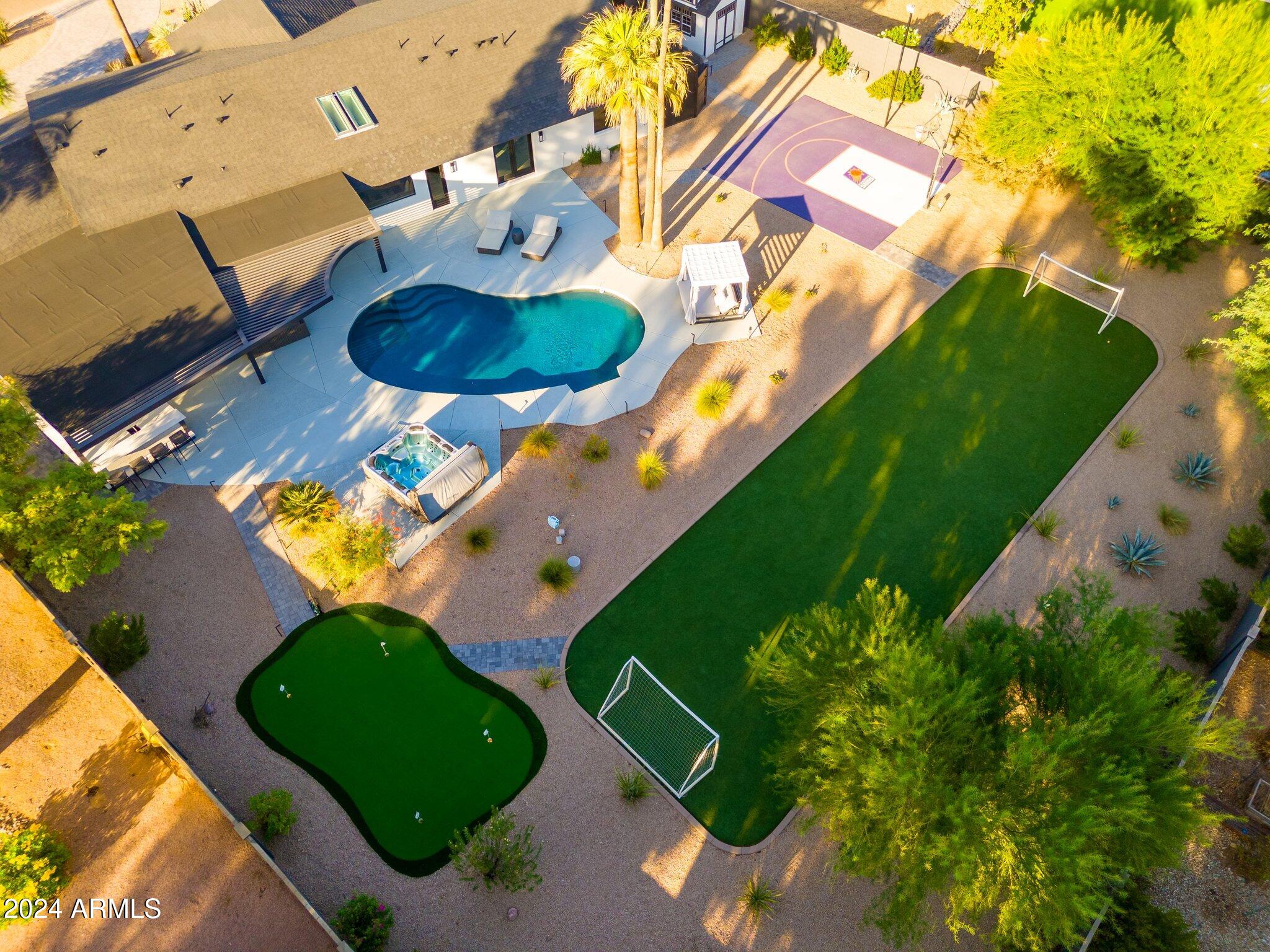 6025 East Charter Oak Road Scottsdale, AZ 85254 - Photo 73 of 115 an aerial view of a house a yard and a swimming pool