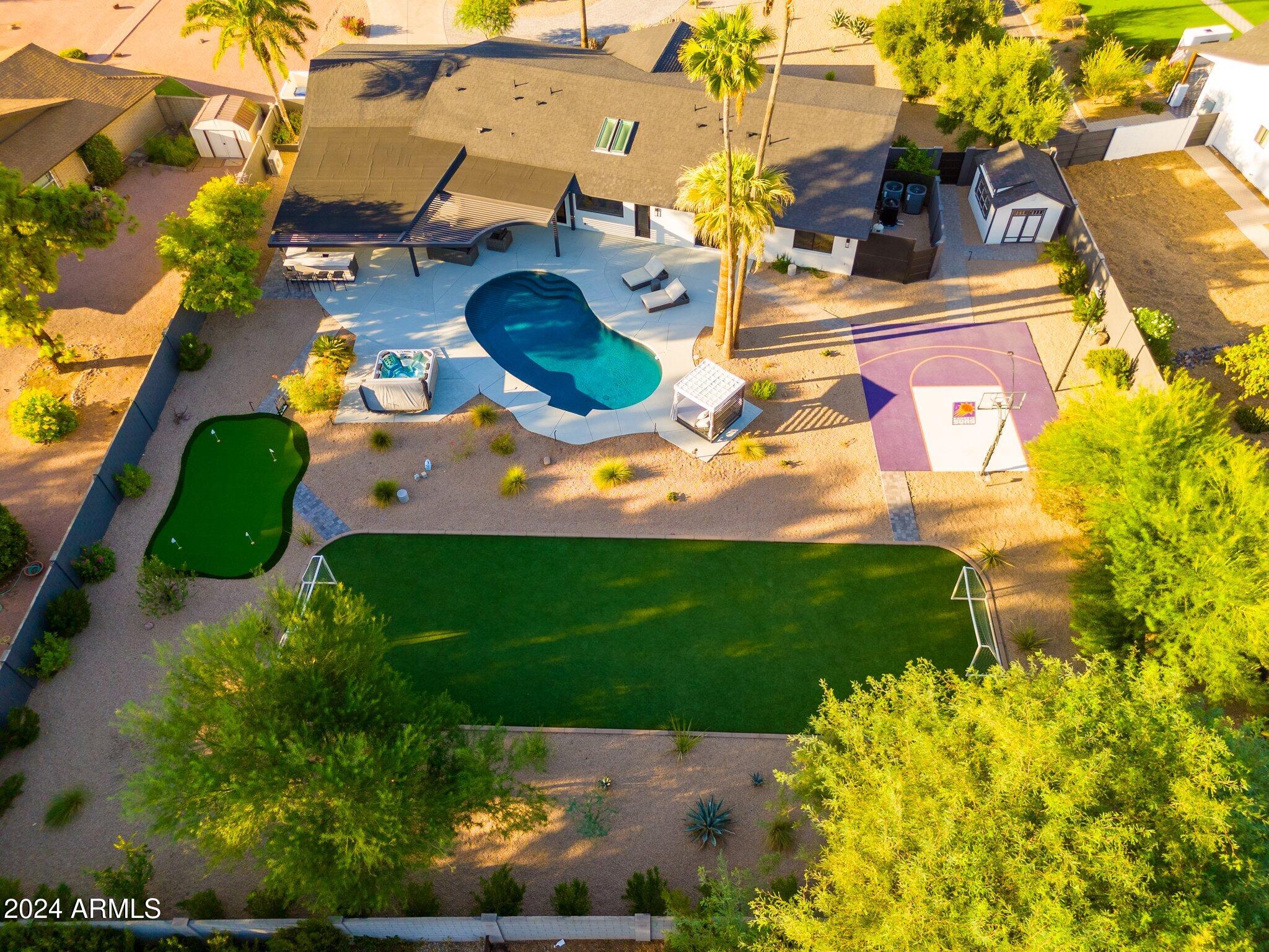 6025 East Charter Oak Road Scottsdale, AZ 85254 - Photo 74 of 115 an aerial view of a house with a yard and large trees