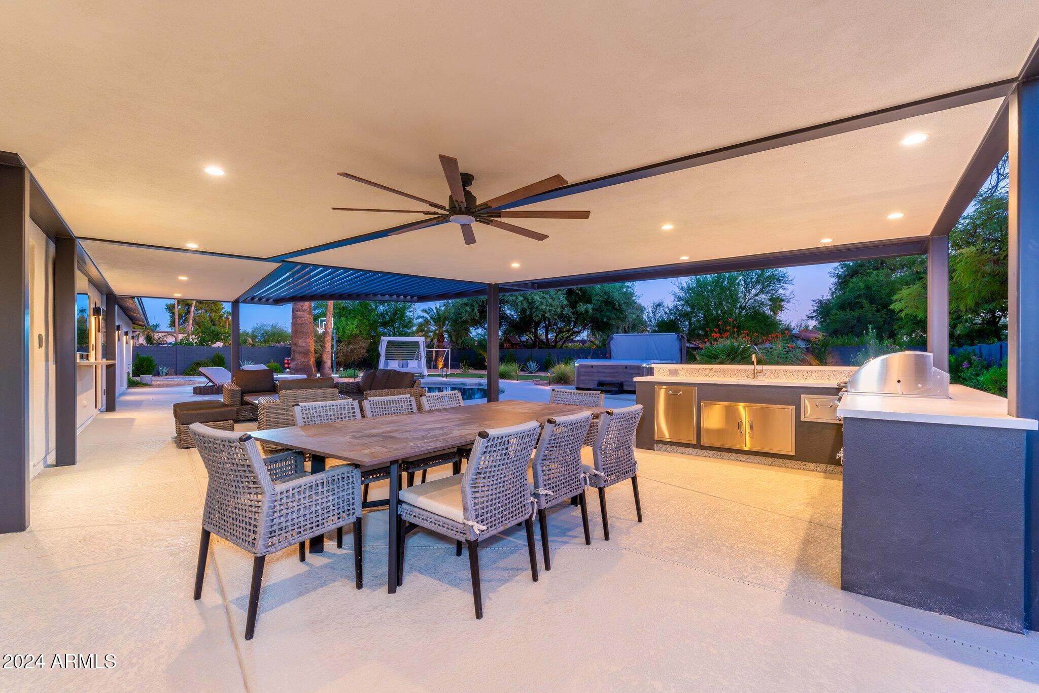 6025 East Charter Oak Road Scottsdale, AZ 85254 - Photo 79 of 115 a view of a patio with a dining table and chairs