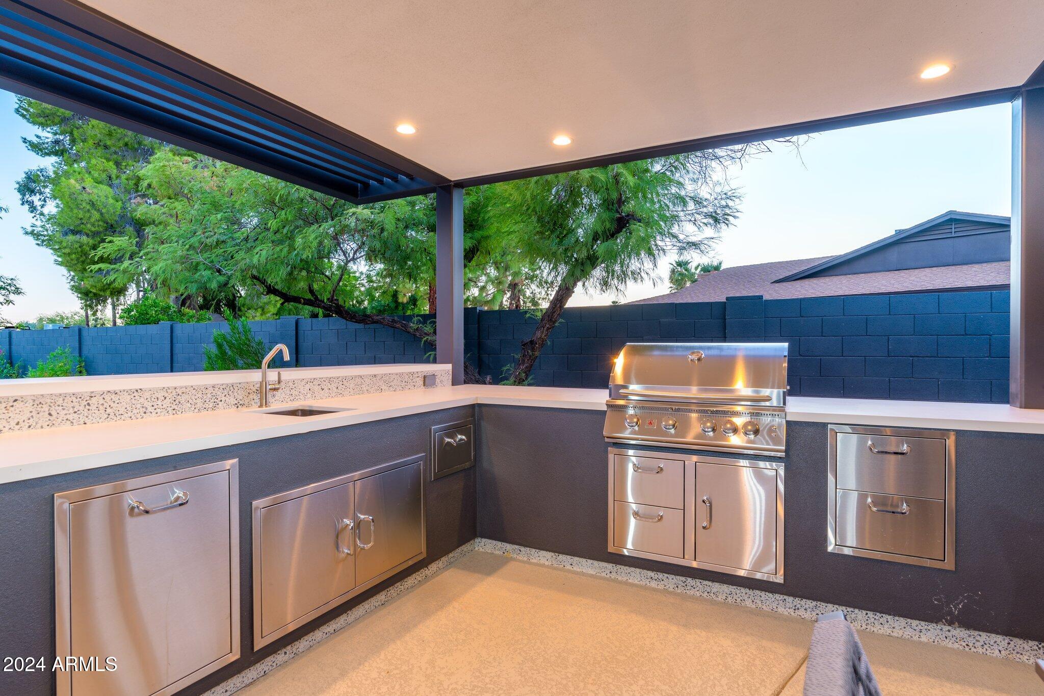 6025 East Charter Oak Road Scottsdale, AZ 85254 - Photo 80 of 115 a kitchen with a sink and large window