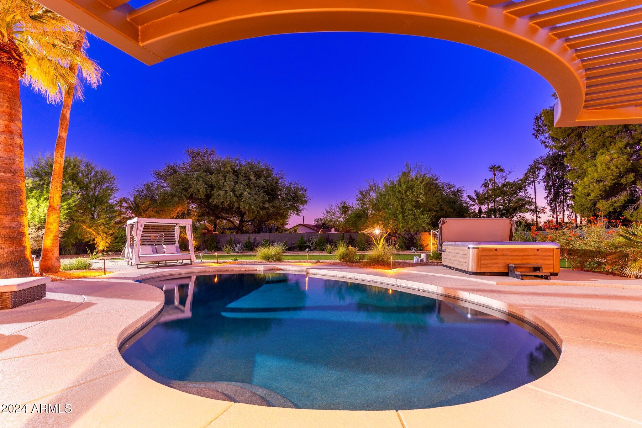 6025 East Charter Oak Road Scottsdale, AZ 85254 - Photo 83 of 115 a view of a swimming pool with an outdoor seating