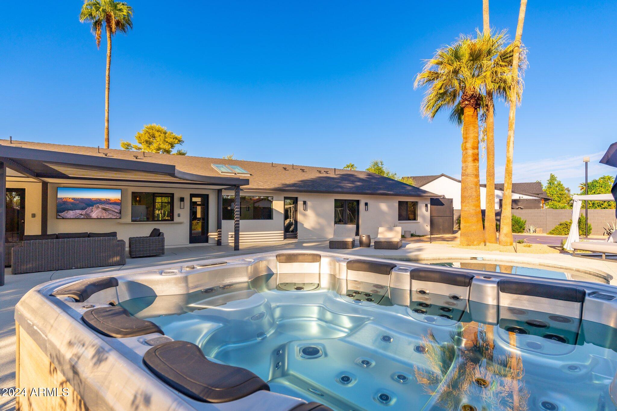 6025 East Charter Oak Road Scottsdale, AZ 85254 - Photo 90 of 115 a view of a house with swimming pool outdoor seating