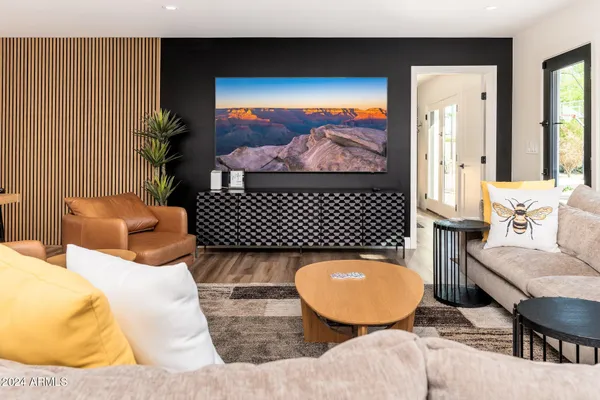 a living room with furniture kitchen view and a table