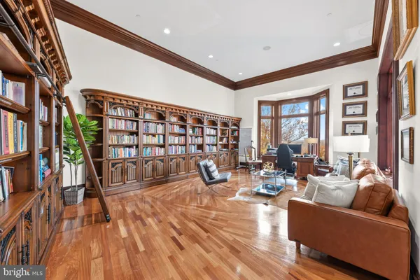 a living room with fireplace furniture and a book shelf