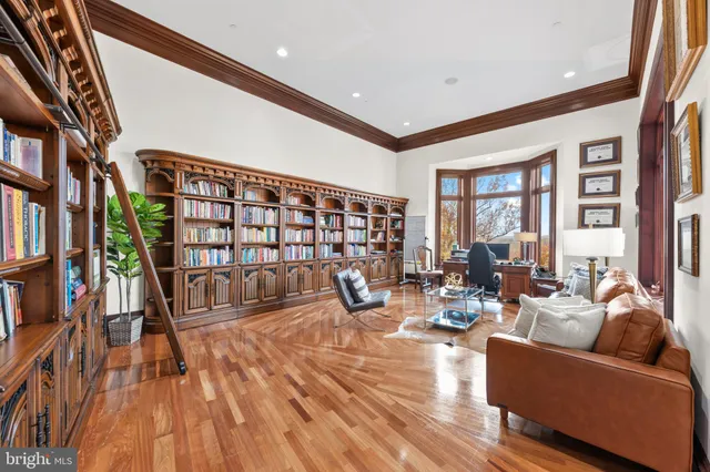 a living room with fireplace furniture and a book shelf