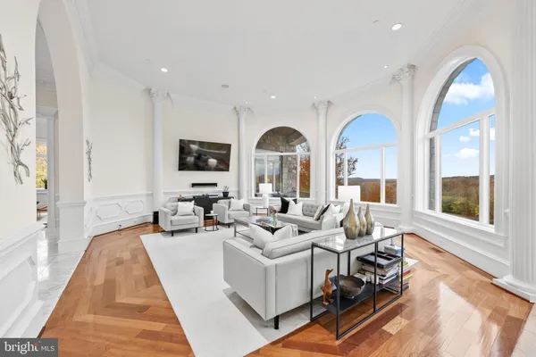 a living room with furniture fireplace and a large window