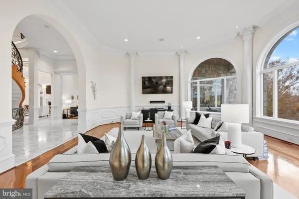 a living room with fireplace furniture and a large window