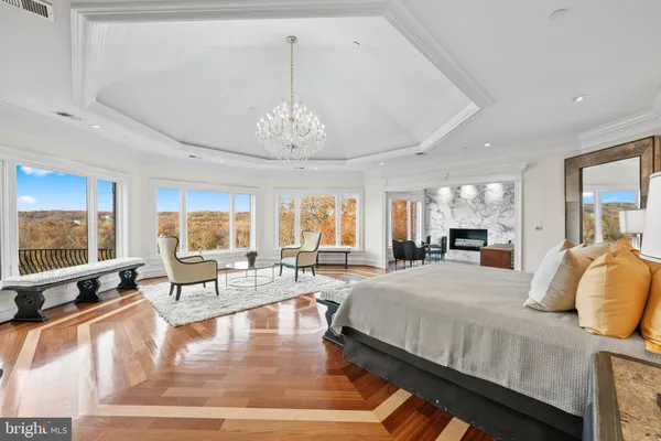 a bedroom with a large bed and a chandelier