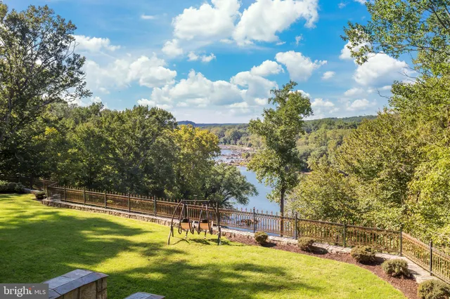 a view of a swimming pool with a yard