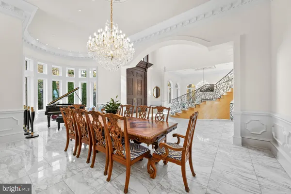 a view of a dining room with furniture and chandelier