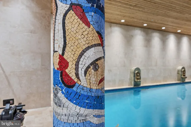 a view of water heater room with wooden floor