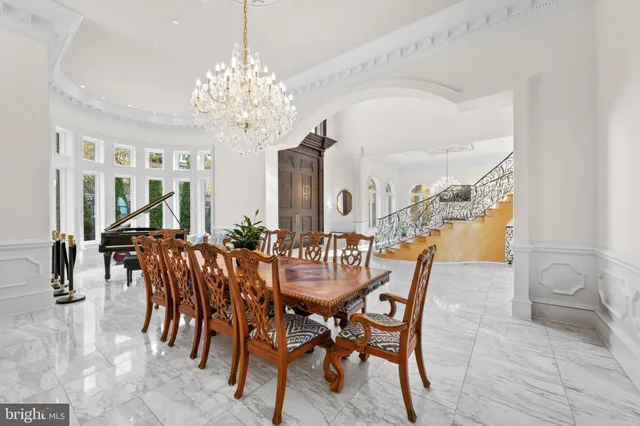 a view of a dining room with furniture and chandelier