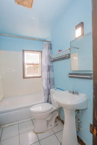 a bathroom with a sink toilet and a mirror