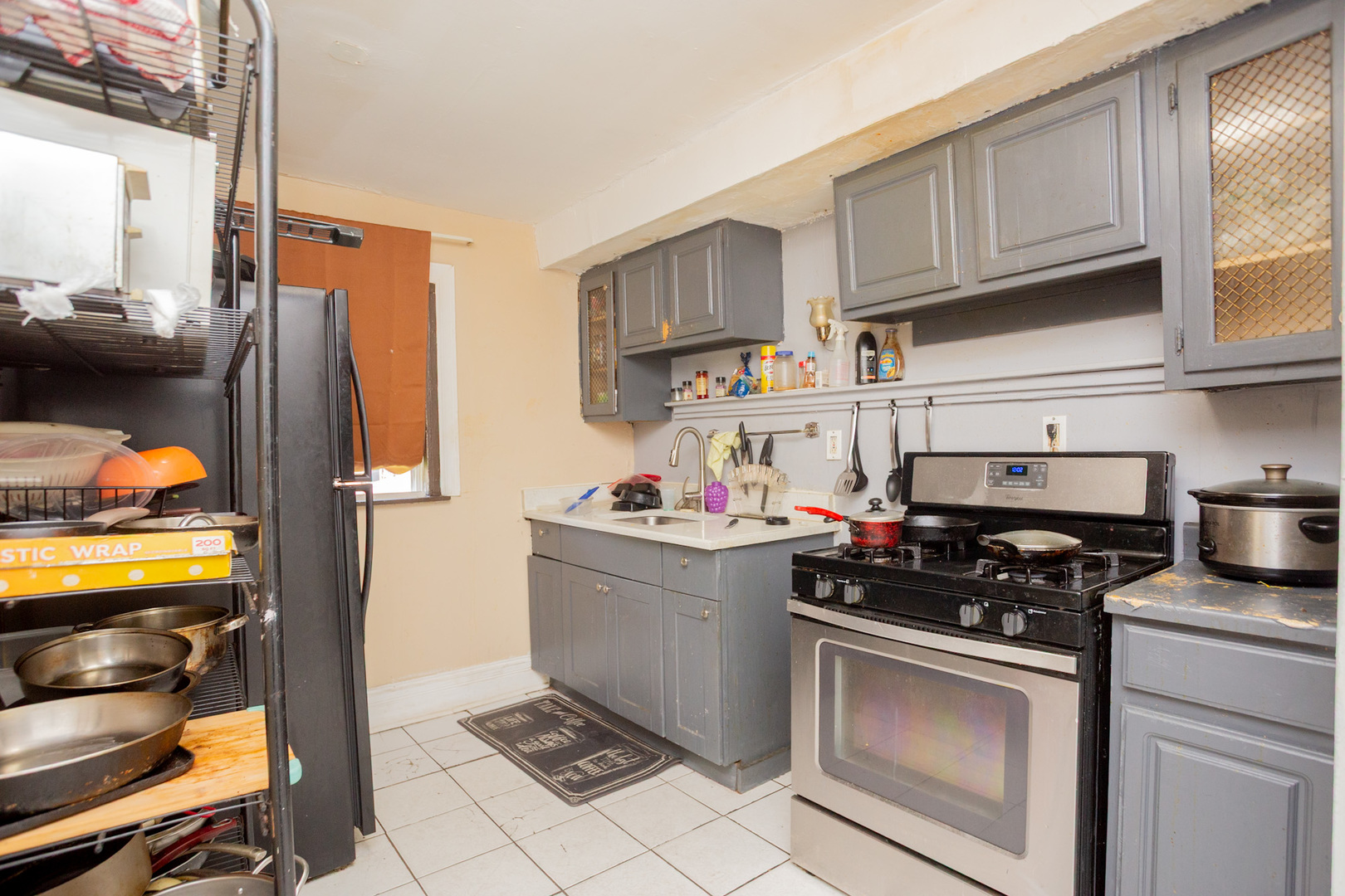 6049 South Champlain Avenue Chicago, IL 60637 - Photo 17 of 46 a kitchen with stainless steel appliances a stove a refrigerator and cabinets
