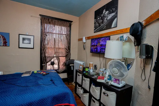 a bedroom with bed and a window