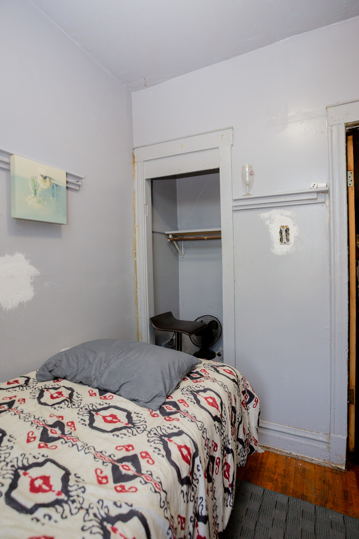 6049 South Champlain Avenue Chicago, IL 60637 - Photo 24 of 46 a bedroom with a bed and a window