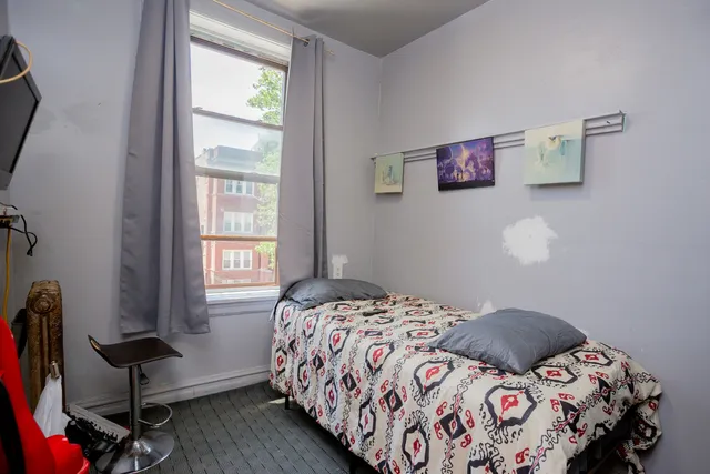 a bedroom with a bed and a window