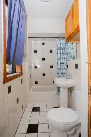 a bathroom with a toilet a sink and a shower
