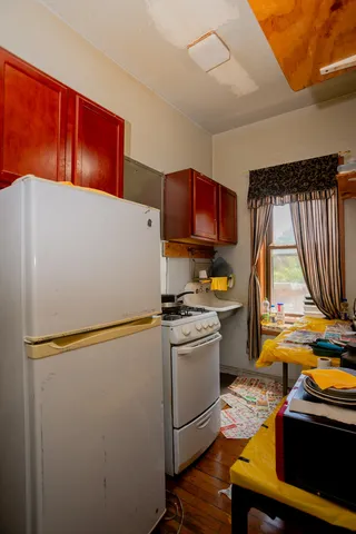 a kitchen with stainless steel appliances a refrigerator sink and wooden floor