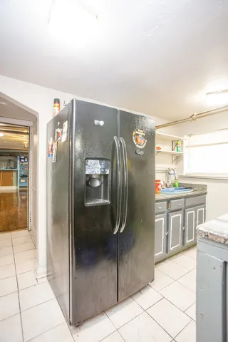 a kitchen with stainless steel appliances granite countertop a refrigerator and a stove