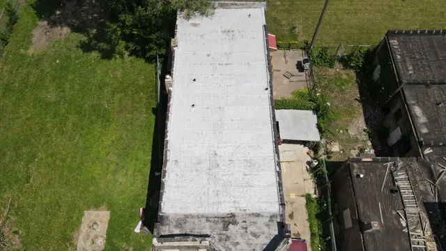 an aerial view of a house with a yard