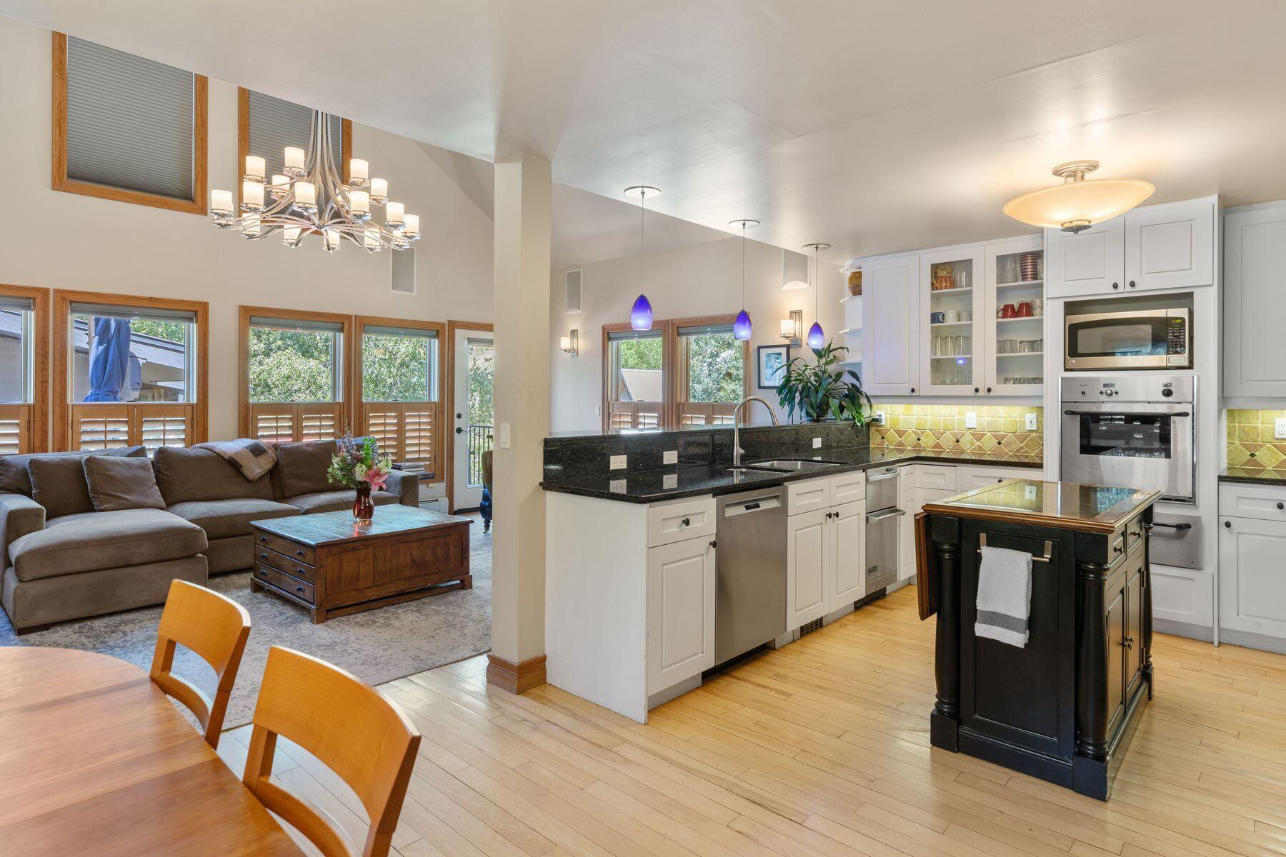 239 North Davis Street Telluride, CO 81435 - Photo 13 of 42 a kitchen with kitchen island granite countertop a stove and cabinets