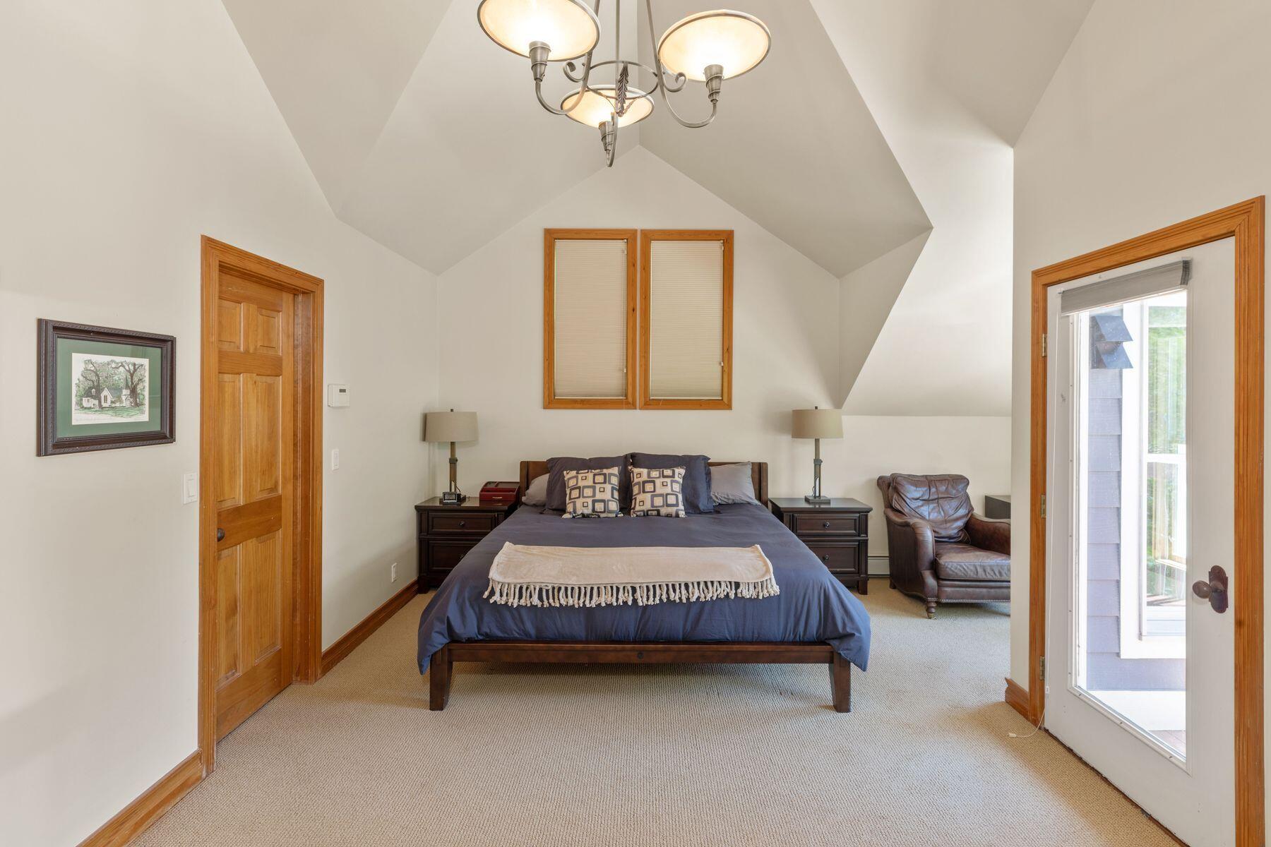 239 North Davis Street Telluride, CO 81435 - Photo 23 of 42 a bedroom with a bed and a chandelier