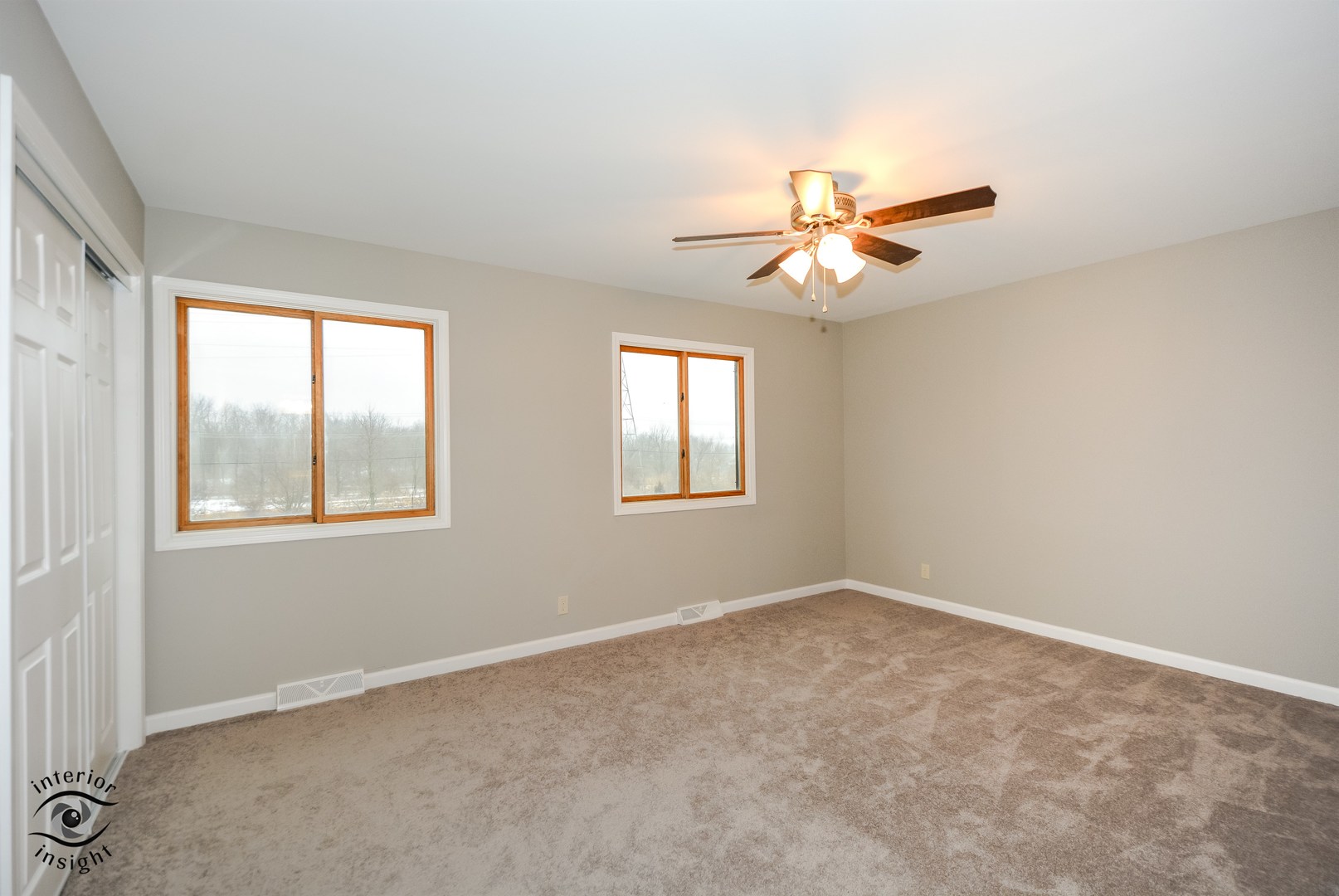 266 Circlegate Road New Lenox, IL 60451 - Photo 17 of 25 an empty room with windows and fan chandelier fan