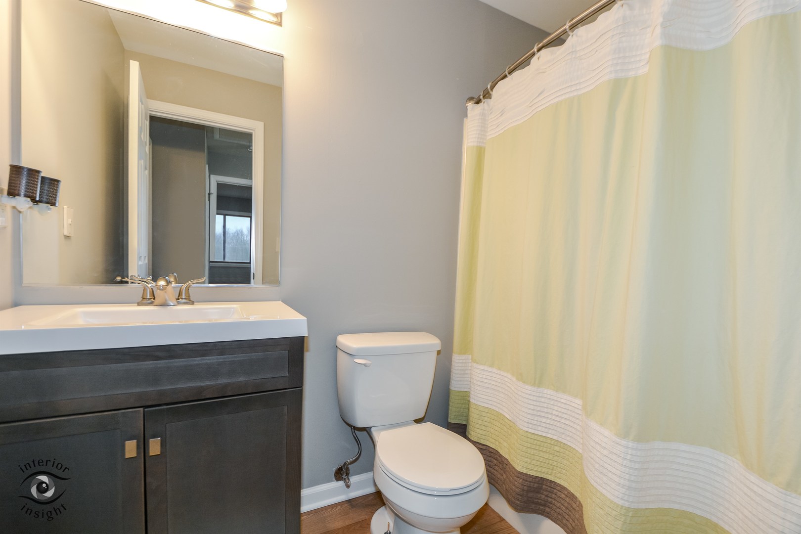 266 Circlegate Road New Lenox, IL 60451 - Photo 21 of 25 a bathroom with a sink a toilet a mirror and shower curtain