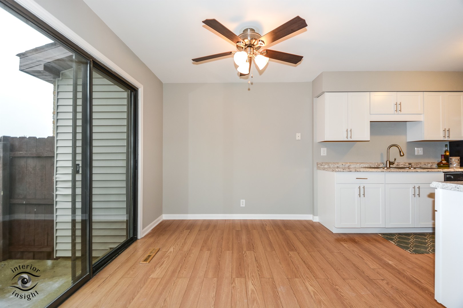 266 Circlegate Road New Lenox, IL 60451 - Photo 6 of 25 a kitchen with a wooden floor and a ceiling fan