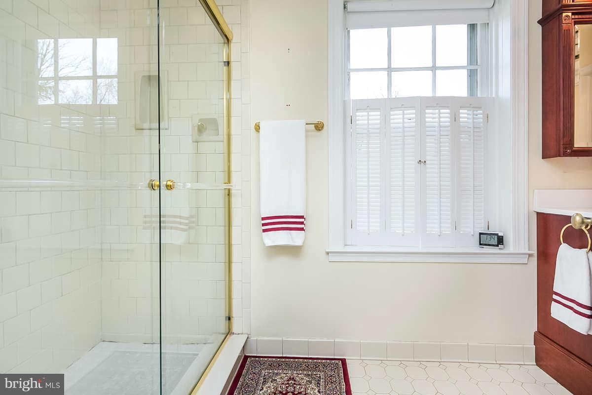 14 East Bishops Road Baltimore, MD 21218 - Photo 21 of 28 a bathroom with a window and a shower