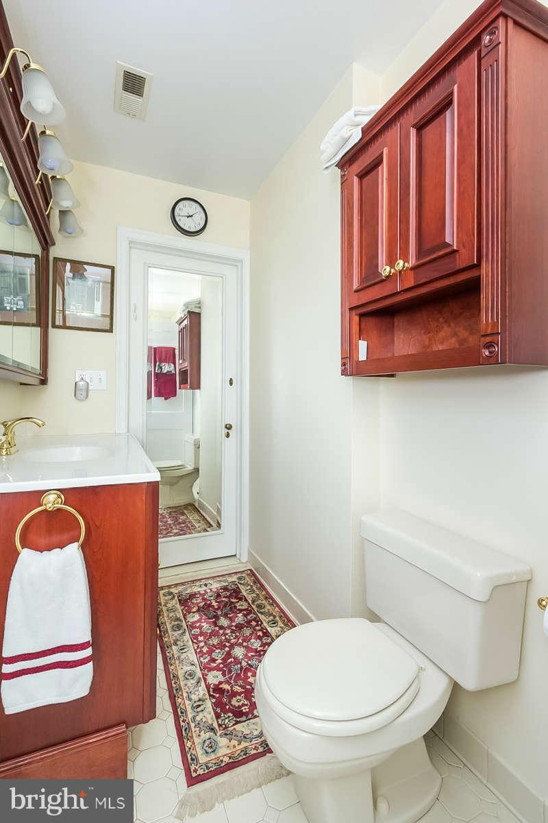 14 East Bishops Road Baltimore, MD 21218 - Photo 22 of 28 a bathroom with a toilet a sink and a bathtub