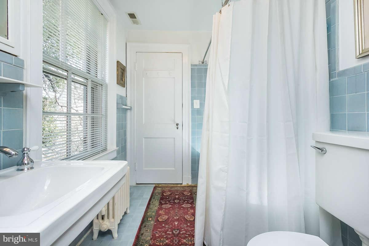 14 East Bishops Road Baltimore, MD 21218 - Photo 24 of 28 a bathroom with a sink and a mirror