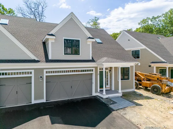 a front view of a house with parking space