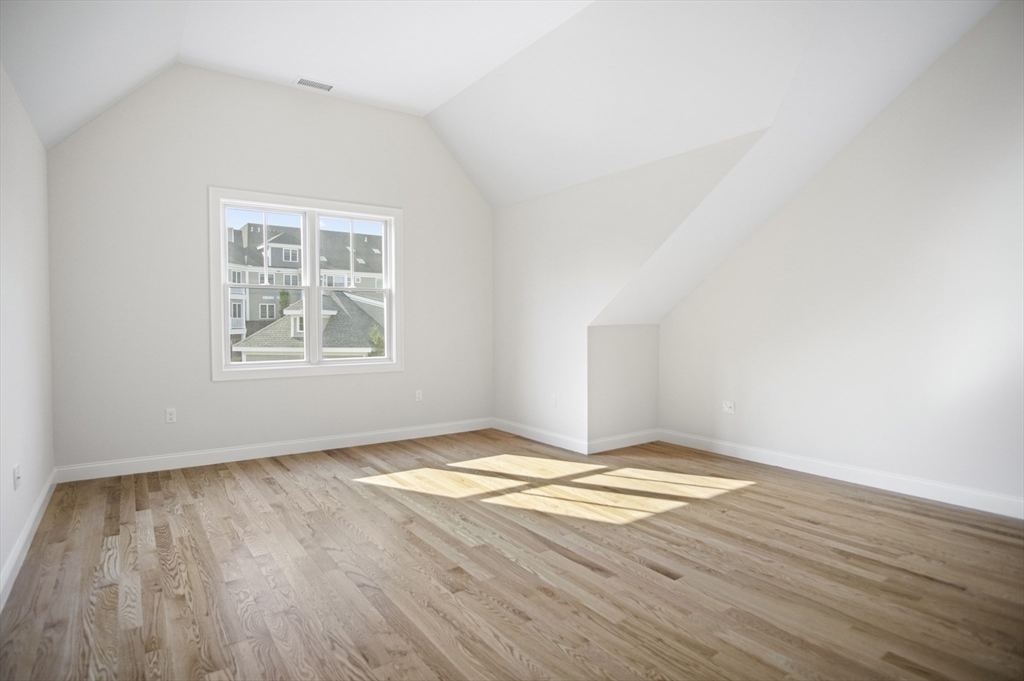 18 Talbot Lane, Unit 18 Reading, MA 01867 - Photo 25 of 33 an empty room with wooden floor and windows