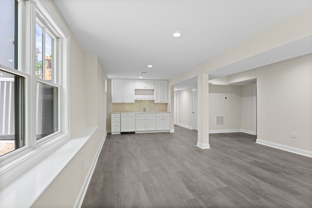 18 Talbot Lane, Unit 18 Reading, MA 01867 - Photo 29 of 33 a view of an empty room with a window and wooden floor