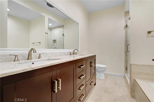 a spacious bathroom with a double vanity sink mirror and toilet