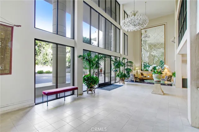 a living room filled with furniture and a chandelier