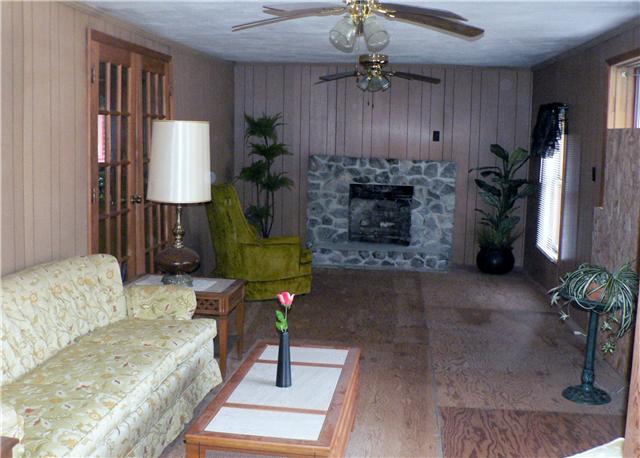 219 Summitville Road Manchester, TN 37355 - Photo 7 of 13 Large den with paneling, double ceiling fans and rock fireplace. Very nice room for entertaining on the holidays.