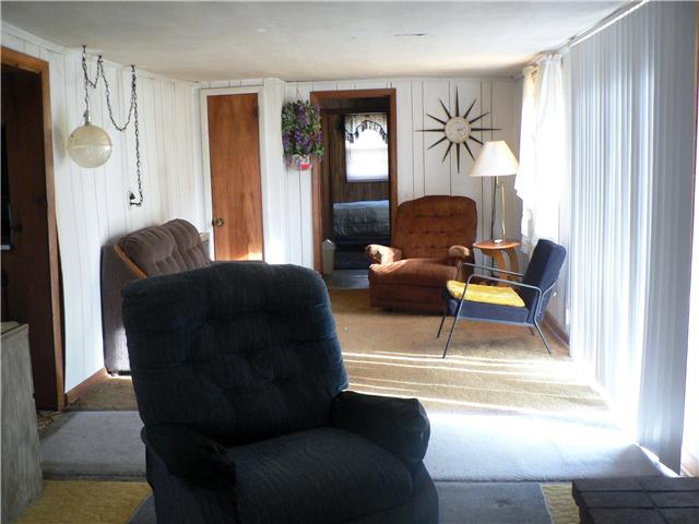 219 Summitville Road Manchester, TN 37355 - Photo 8 of 13 Cozy living room with french doors, carpet and lots of space.