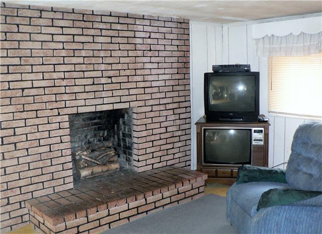 219 Summitville Road Manchester, TN 37355 - Photo 9 of 13 Living room also features brick fireplace.