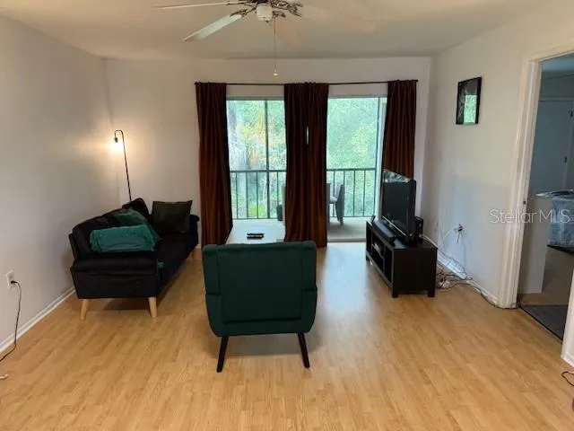 a living room with furniture and a large window