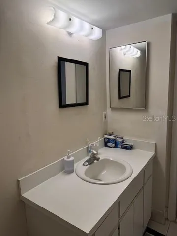 a bathroom with a sink and a mirror