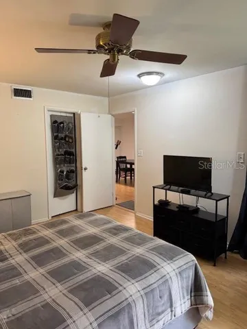 a bedroom with a bed and a flat screen tv