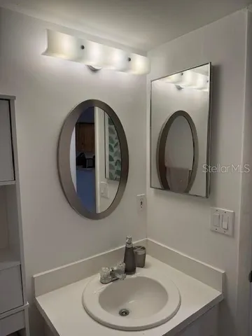 a bathroom with a sink and a mirror