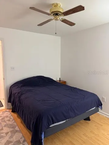 a bed sitting in a bedroom next to a window